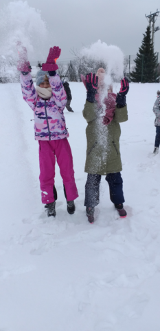Dziewczynki podrzucają śnieg