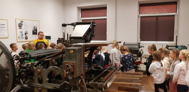 Dzieci oglądają maszyny drukarskie