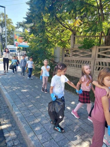 Dzieci idą chodnikiem.